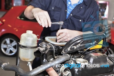 car Mechanic repairing car engine Stock Photo