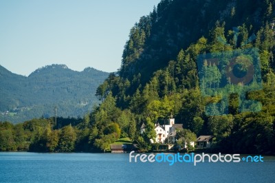 Castle Schloss On The Shoreline Of Lake Hallstatt Stock Photo
