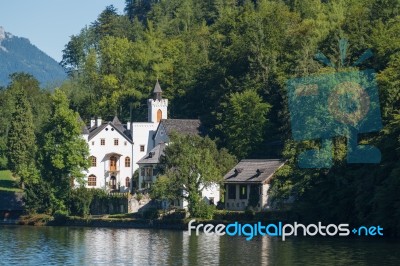 Castle Schloss On The Shoreline Of Lake Hallstatt Stock Photo