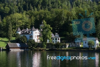 Castle Schloss On The Shoreline Of Lake Hallstatt Stock Photo