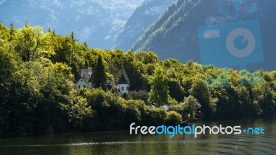 Castle Schloss On The Shoreline Of Lake Hallstatt Stock Photo