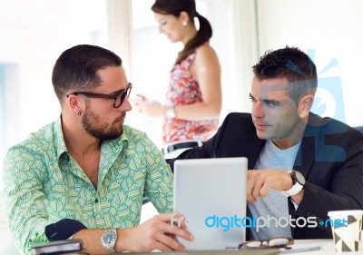 Casual Executives Working Together At A Meeting With Digital Tab… Stock Photo