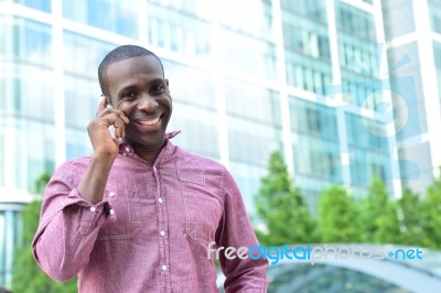 Casual Male Talking On Mobile Phone Stock Photo
