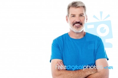 Casual Man Standing With His Arms Crossed Stock Photo