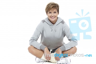 Casual Shot Of A Fit Blonde Sitting On The Floor Stock Photo