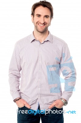 Casual Studio Shot Of A Cheerful Young Man Stock Photo
