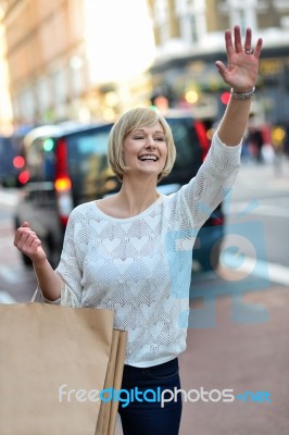 Casual Woman Hailing A Taxi Cab Stock Photo