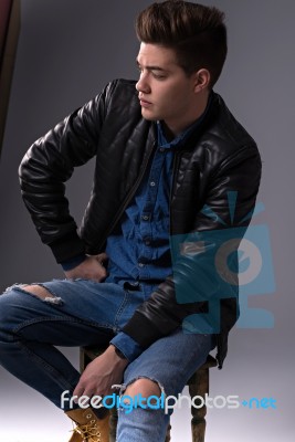 Casual Young Man In Black Leather Jacket And Denim Jeans Stock Photo