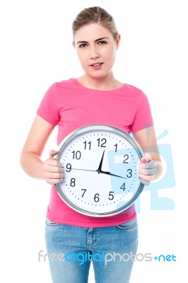 Casual Young Woman Holding A Clock Stock Photo Casual Young Woman Holding A Clock Stock Photo