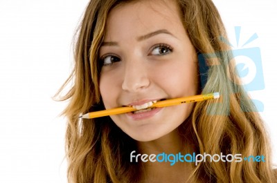Caucasian Girl Biting Pencil Stock Photo