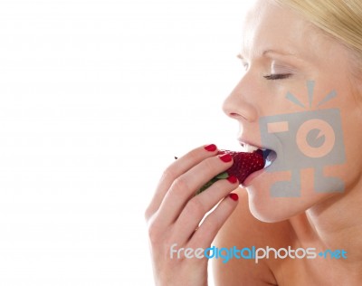 Caucasian Lady tasting Strawberry Stock Photo