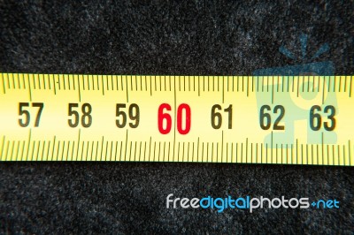 Centimeters Near A Tape Measure On The Number Sixty Stock Photo