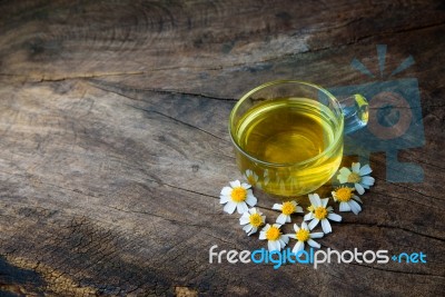 Chamomile Tea And Chamomile Flower On Old Wooden Table Stock Photo