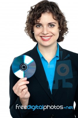 Charming Corporate Lady Holding Data Disc Stock Photo