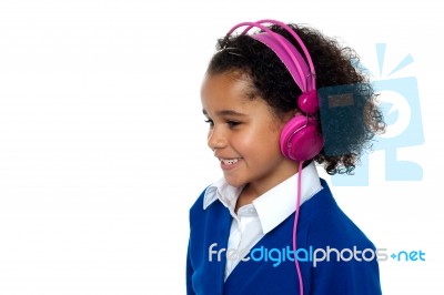 Charming Young Kid Listening To Music Stock Photo