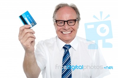 Cheerful Aged Employer Holding Up A Cash Card Stock Photo