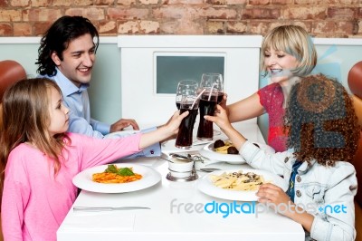 Cheerful Family Of Four Celebrating, Cheers! Stock Photo