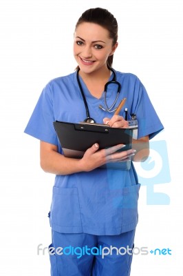 Cheerful Female Physician Writing Prescription Stock Photo