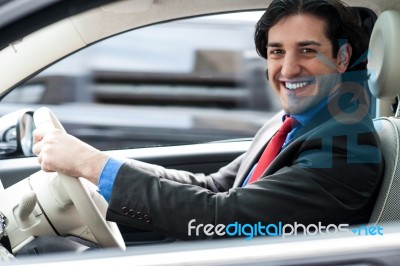 Cheerful Man Driving His New Luxurious Car Stock Photo