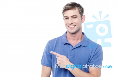 Cheerful Man Pointing His Finger Away Stock Photo