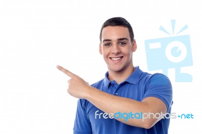 Cheerful Teenager Pointing Away Stock Photo