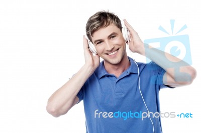 Cheerful Young Man Enjoying  Music Stock Photo