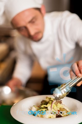 Chef Arranging Tossed Salad In A White Bowl Stock Photo