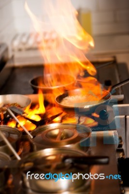 Chef Cooking In Kitchen Stove Stock Photo