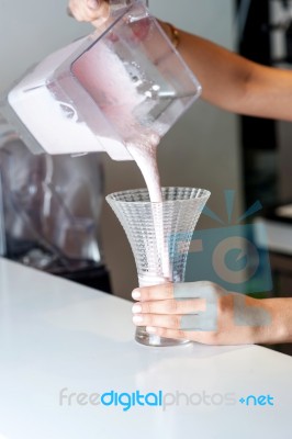 Chef Filling Glass With Milkshake Stock Photo