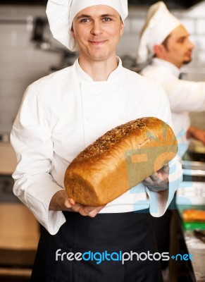 Chef Showing Freshly Baked Whole Grain Bread Stock Photo