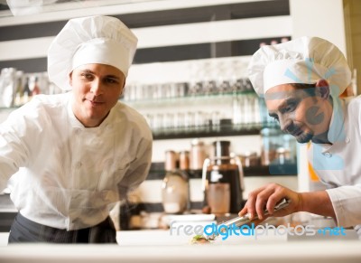 Chef Watching His Assistant Arranging Dish Stock Photo Chef Watching His Assistant Arranging Dish Stock Photo