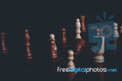 Chess Pieces On A Chess Board Background Stock Photo