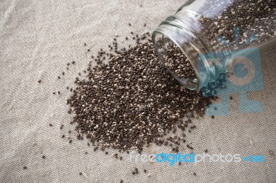 Chia Seeds Spilled Out Of Bottle Stock Photo