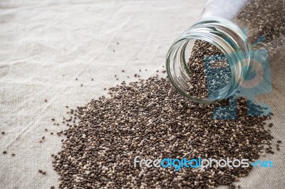 Chia Seeds Spilled Out Of Bottle Stock Photo