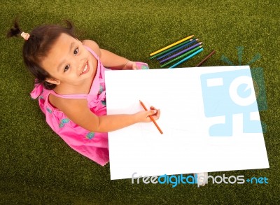 Child Drawing With Pencils Stock Photo