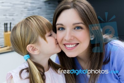 Child Giving A Kiss To His Mother On The Cheek Stock Photo