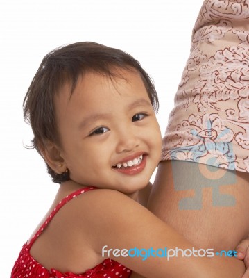 Child Hugging Her Mother's Leg Stock Photo