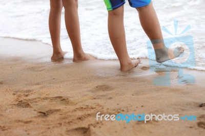 Children Are Walking On Beach Stock Photo