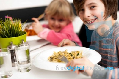 Children Enjoying Their Meals Stock Photo