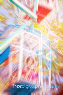 Children On A Rotating Ferris Wheel Stock Photo