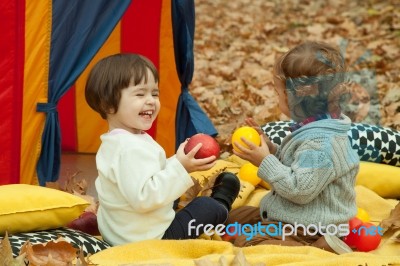 Children Play In The Park And Eating Apple Stock Photo