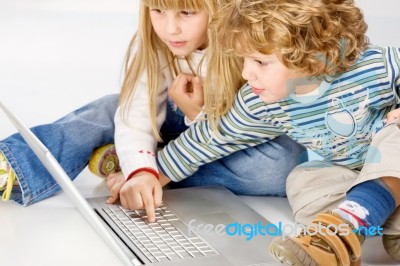 Children Turning On Computer Stock Photo