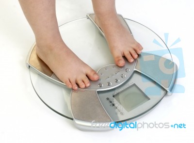 Childs Feet On Weighing Scale Stock Photo