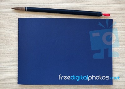 Chinese Writing Brush With Blue Notebook Stock Photo