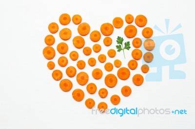 Chopped Carrot Slices Heart Shape And Parsley Leaves Stock Photo