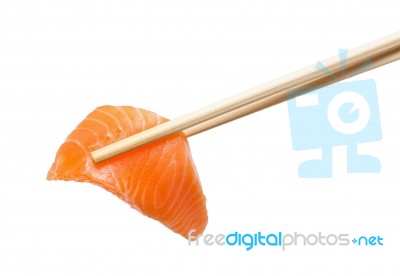 Chopsticks With Sliced Raw Salmon Stock Photo