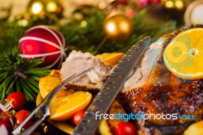 Christmas Baked Duck Served With Potatoes, Orange And Tomatoes Stock Photo