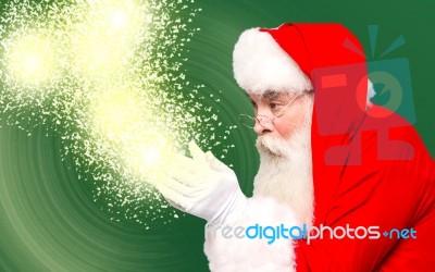 Christmas Theme, Santa Claus With Magic Lights Stock Photo