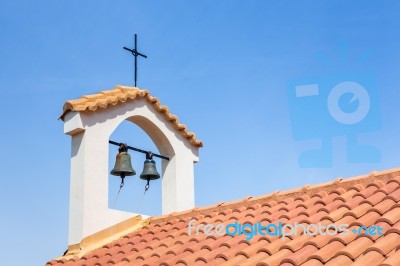 Church Tower On Roof With Bells And Cross Stock Photo