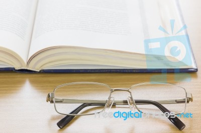 Close Up Glasses And A Book On The Desk Stock Photo